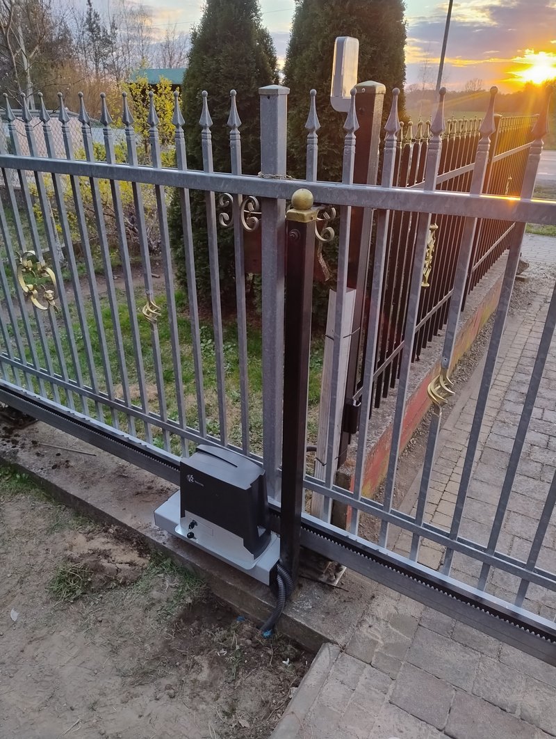 Napęd bramy przesuwnej V2 zamontowany przy kutej bramie z grotami